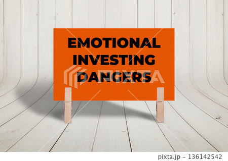 Concept words Emotional Investing Dangers, Orange Concrete Texture Rectangle Card Held By Clothespin Wooden Texture Background, Business and Emotional Investing Dangers Theme 136142542