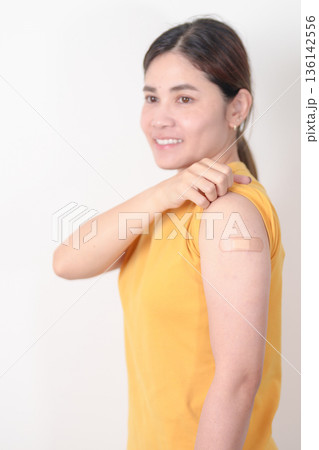 Adult Woman with bandage after received vaccine. Vaccination and Immunization for Influenza, HPV, Zoster, IPD, DTP or Diphtheria, Tetanus and Pertussis, MMR, Hepatitis B, Covid and Nipha virus vaccine Adult Woman with bandage after received vaccine. Vaccination and Immunization for Influenza, HPV, Zoster, IPD, DTP or Diphtheria, Tetanus and Pertussis, MMR, Hepatitis B, Covid and Nipha virus vaccine 136142556