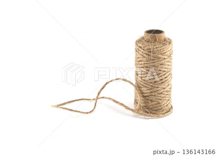 Spool of natural jute twine on a white background, ready for crafting and packaging projects 136143166
