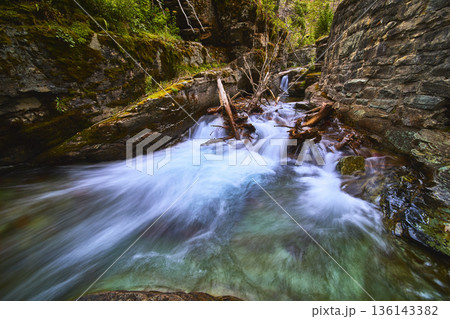 Rushing Waterfall and River Flow Through Rocky Sunrift Gorge in Glacier National Park 136143382
