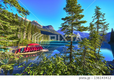 Canoe Dock Reflections on Turquoise Lake with Pine Trees and Mountain Scenery Canoe Dock Reflections on Turquoise Lake with Pine Trees and Mountain Scenery 136143412