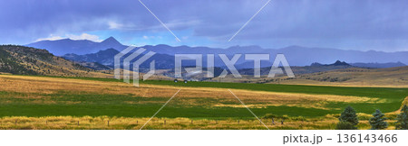 Panoramic Wyoming Mountain Landscape with Rolling Fields and Dramatic Sky Layers 136143466
