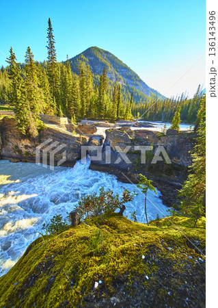 Natural Bridge Rushing River and Mountain Sunrise in Lush Forest Landscape Natural Bridge Rushing River and Mountain Sunrise in Lush Forest Landscape 136143496