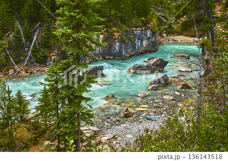 Turquoise River Flowing Through Rocky Canyon and Forest in Pristine Wilderness 136143518
