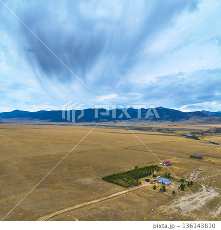 Aerial Wyoming Panorama Wide Open Fields Rural Farmhouses and Distant Mountains Aerial Wyoming Panorama Wide Open Fields Rural Farmhouses and Distant Mountains 136143810