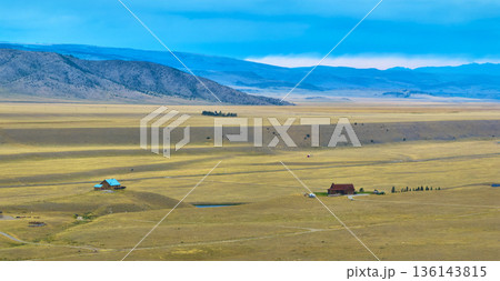 Aerial Wyoming Ranch Houses Expansive Plains and Distant Mountain Panorama 136143815