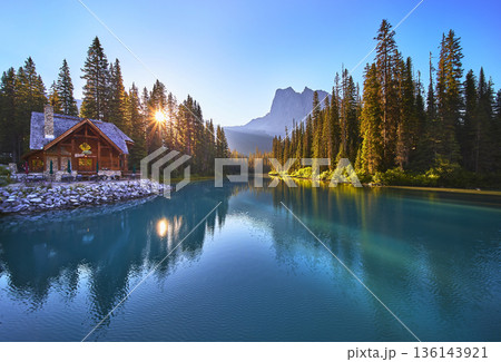 Sunrise Lodge Reflected in Tranquil Lake with Forest and Mountain View Golden Hour Sunrise Lodge Reflected in Tranquil Lake with Forest and Mountain View Golden Hour 136143921