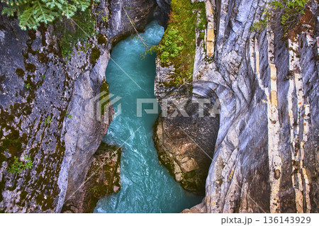 Top Down Turquoise River Flowing Through Rugged Canyon Walls and Lush Vegetation Top Down Turquoise River Flowing Through Rugged Canyon Walls and Lush Vegetation 136143929