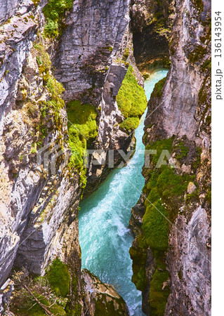 Aerial Turquoise River Flowing Through Mossy Rocky Canyon Walls Aerial Turquoise River Flowing Through Mossy Rocky Canyon Walls 136143954