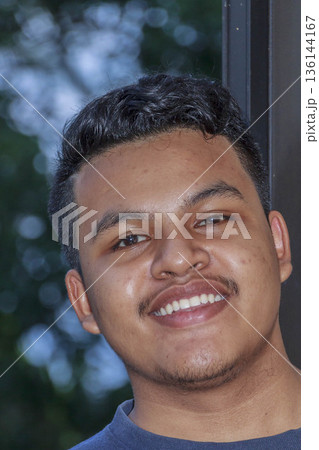 portrait of a young man smiling portrait of a young man smiling 136144167