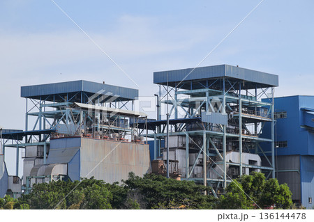 Industrial Power Plant Infrastructure in Daytime, Showing Complex Structures and Natural Light for Energy Production and Supply Chain Industrial Power Plant Infrastructure in Daytime, Showing Complex Structures and Natural Light for Energy Production and Supply Chain 136144478