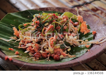 Gado-Gado Indonesian Salad with Peanut Sauce on Banana Leaf Plate, Traditional Vegetable Dish with Natural Light, Authentic Indonesian Cuisine 136144508