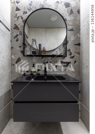 Modern Bathroom Vanity with Round Mirror and Terrazzo Tiles Modern Bathroom Vanity with Round Mirror and Terrazzo Tiles 136144956