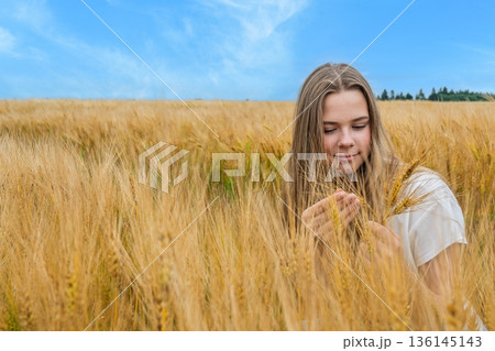 Golden Grains Serene Young Woman Embracing Nature s Beauty in Wheat Field Landscape Golden Grains Serene Young Woman Embracing Nature s Beauty in Wheat Field Landscape 136145143