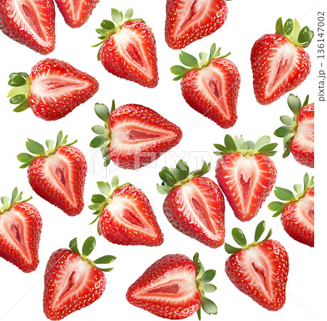 Juicy whole and halved strawberries with green leaves scattered and isolated on white background, freshness and healthy eating 136147002