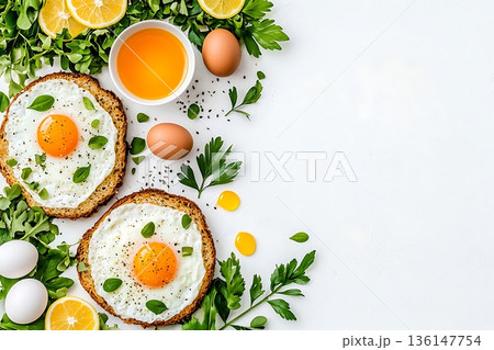Fresh Breakfast Composition with Eggs, Greens, Citrus Fruits, and Olive Oil on White Background Fresh Breakfast Composition with Eggs, Greens, Citrus Fruits, and Olive Oil on White Background 136147754