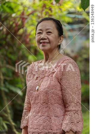 portrait of smiling woman in garden 136148449