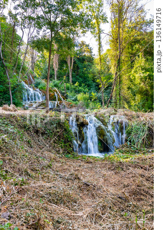 Waterfalls at Skradinski Buk, national nature park Krka, Croatia. Flowing water in beautiful nature, green plants and trees. Sunny summer day. Waterfalls at Skradinski Buk, national nature park Krka, Croatia. Flowing water in beautiful nature, green plants and trees. Sunny summer day. 136149716