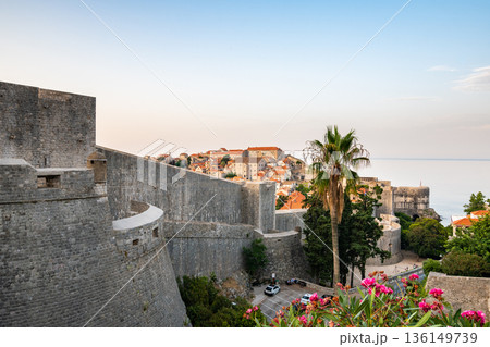 Panoramic view of sunrise over old town of Dubrovnik. Ancient city wall and Minceta tower. Famous tourist destination in Croatia. Summer morning, soft warm light. UNESCO heritage. Panoramic view of sunrise over old town of Dubrovnik. Ancient city wall and Minceta tower. Famous tourist destination in Croatia. Summer morning, soft warm light. UNESCO heritage. 136149739