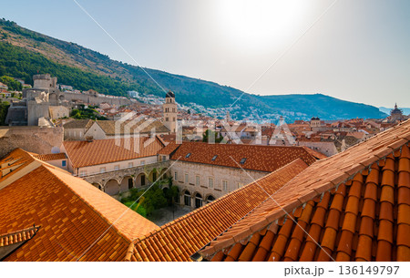 Aerial panoramic view of old city Dubrovnik. Ancient city with big city walls near adriatic sea. View of roofs, sunny summer day. Aerial panoramic view of old city Dubrovnik. Ancient city with big city walls near adriatic sea. View of roofs, sunny summer day. 136149797