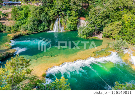 Waterfalls at Krka river, Croatia. Part of the Skradinski Buk waterfall. Famous place in nature park - beautiful tourist destination in Croatia. Fresh green nature, summer weather. 136149811