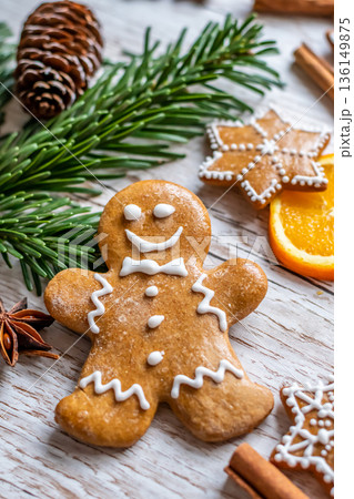 Christmas gingerbread and sweets are placed on wooden desk. Cookies and sweet food in shape of stars and snow flakes. Winter theme, rustic style. Pine trees on the side. Candy stick and other spice. Christmas gingerbread and sweets are placed on wooden desk. Cookies and sweet food in shape of stars and snow flakes. Winter theme, rustic style. Pine trees on the side. Candy stick and other spice. 136149875