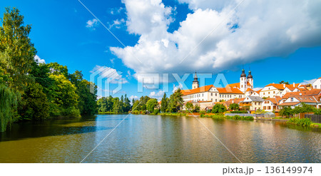 Panorama view of Telc city, Czech Republic. Historical castle above the lake. UNESCO heritage. Summer day, blue sky with clouds. 136149974
