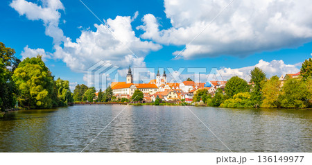 Panorama view of Telc city, Czech Republic. Historical castle above the lake. UNESCO heritage. Summer day, blue sky with clouds. 136149977
