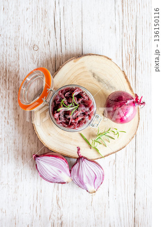 Red onion marmalade placed on wooden trunk with wood texture background. Jam from onion is delicious part of French cuisine. Homemade jam in transparent glass, vibrant colors, soft light. Red onion marmalade placed on wooden trunk with wood texture background. Jam from onion is delicious part of French cuisine. Homemade jam in transparent glass, vibrant colors, soft light. 136150116