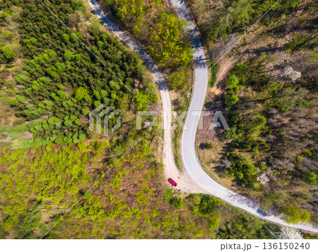 Aerial top down drone view of curve road in the forest. Aerial top down drone view of curve road in the forest. 136150240