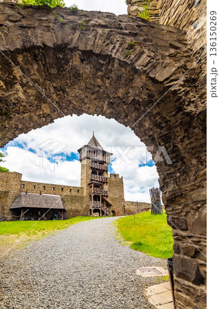 Medieval castle Helfstyn, Czech Republic. Ancient castle in gothic style. Castle walls and interiors, beautiful old tower. Summer weather, blue sky with clouds. Famous trip destination. 136150269