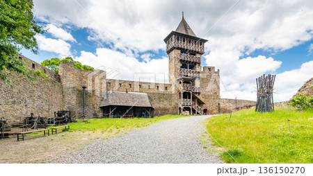 Medieval castle Helfstyn, Czech Republic. Ancient castle in gothic style. Castle walls and interiors, beautiful old tower. Summer weather, blue sky with clouds. Famous trip destination. Medieval castle Helfstyn, Czech Republic. Ancient castle in gothic style. Castle walls and interiors, beautiful old tower. Summer weather, blue sky with clouds. Famous trip destination. 136150270