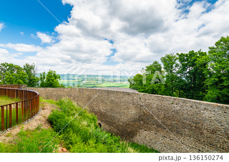 Medieval castle Helfstyn, Czech Republic. Ancient castle in gothic style. Castle walls and interiors, beautiful old tower. Summer weather, blue sky with clouds. Famous trip destination. Medieval castle Helfstyn, Czech Republic. Ancient castle in gothic style. Castle walls and interiors, beautiful old tower. Summer weather, blue sky with clouds. Famous trip destination. 136150274