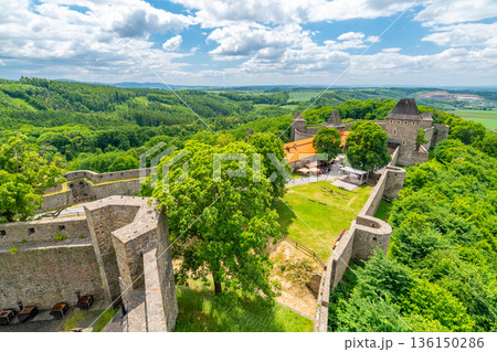 Medieval castle Helfstyn, Czech Republic. Ancient castle in gothic style. Castle walls and interiors, beautiful old tower. Summer weather, blue sky with clouds. Famous trip destination. Medieval castle Helfstyn, Czech Republic. Ancient castle in gothic style. Castle walls and interiors, beautiful old tower. Summer weather, blue sky with clouds. Famous trip destination. 136150286