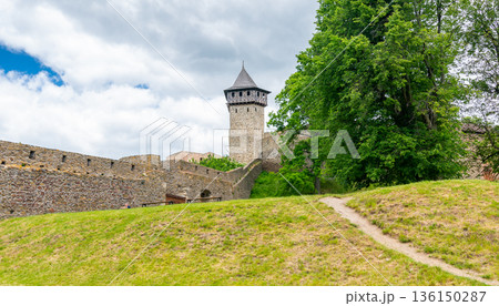 Medieval castle Helfstyn, Czech Republic. Ancient castle in gothic style. Castle walls and interiors, beautiful old tower. Summer weather, blue sky with clouds. Famous trip destination. Medieval castle Helfstyn, Czech Republic. Ancient castle in gothic style. Castle walls and interiors, beautiful old tower. Summer weather, blue sky with clouds. Famous trip destination. 136150287