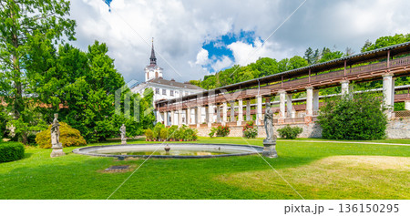 Lysice castle, Czech Republic. Famous baroque castle built in 14th century. Beautiful formal garden, palm trees and flowers. Promenade near the castle. Sunny day, dramatic clouds before storm. Lysice castle, Czech Republic. Famous baroque castle built in 14th century. Beautiful formal garden, palm trees and flowers. Promenade near the castle. Sunny day, dramatic clouds before storm. 136150295