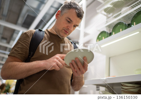 Man shopping in kitchenware section Man shopping in kitchenware section 136150330