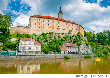 Panoramic view of castle above river in Ledec nad Sazavou. Sazava river is famous target for kayaking. Summer weather with dramatic clouds. Czech Republic. 136150451