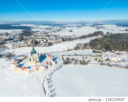 Aerial drone view of Pilgrimage Church of Saint John of Nepomuk, Zdar nad Sazavou, Czech Republic. UNESCO heritage. Ancient monastery at Zelena Hora hill. Winter weather with snow, blue sky. Aerial drone view of Pilgrimage Church of Saint John of Nepomuk, Zdar nad Sazavou, Czech Republic. UNESCO heritage. Ancient monastery at Zelena Hora hill. Winter weather with snow, blue sky. 136150487