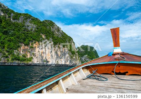 View of limestone rock at Ko Phi Phi islands, Thailand. View from long tailed boat. Exotic and tropic nature, summer paradise. View of limestone rock at Ko Phi Phi islands, Thailand. View from long tailed boat. Exotic and tropic nature, summer paradise. 136150599