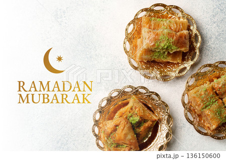 Special desserts served during Ramadan celebrations with sweets displayed on gold plates 136150600