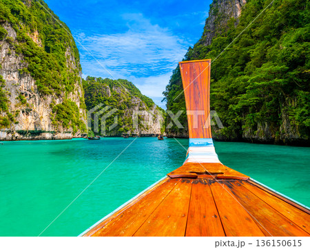 View of Pi Leh lagoon (also known as Green Lagoon) at Ko Phi Phi islands, Thailand. View from typical long tailed boat. Typical Thai picture of tropical paradise. Limestone rock and turquoise water. 136150615