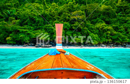 View of monkey beach at Ko Phi Phi islands, Thailand. Famous tropical beach with white sand and turquoise water. View from long tail boat. Summer paradise. 136150617