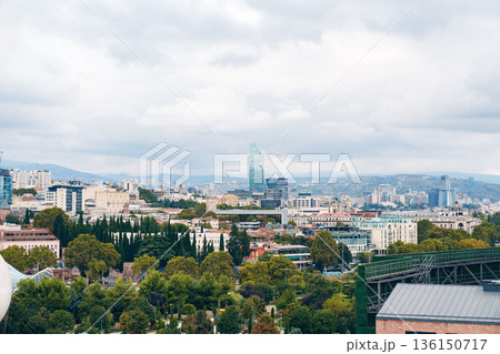 City skyline view with buildings and trees during afternoon in a cloudy weather 136150717