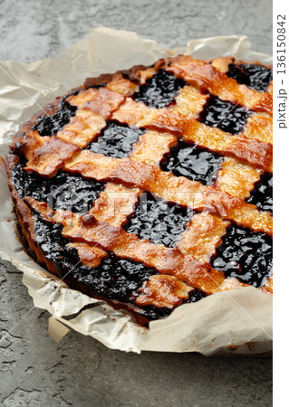 Blackberry pie baked with a golden crust and dark filling on a baking sheet Blackberry pie baked with a golden crust and dark filling on a baking sheet 136150842