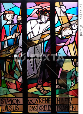 5th Stations of the Cross, Simon of Cyrene carries the cross, stained glass window in Saint Lawrence church in Kleinostheim, Germany 136153021