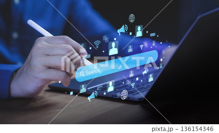 Person using pen on laptop with floating digital search bar and icons, symbolizing online search engine optimization (SEO), data marketing, internet connection, and digital communication concept. 136154346