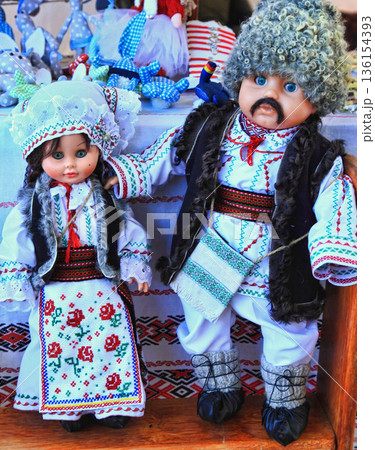 Chisinau, Moldova - October 15,2022: City Day. The dolls are dressed in national Moldavian clothes. Chisinau, Moldova - October 15,2022: City Day. The dolls are dressed in national Moldavian clothes. 136154393