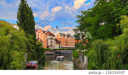 LJUBLJANA, SLOVENIA - JUNE 28, 2014: Ljubljana -Slovenia - city centre, view on the river. Ljubljana is the business and cultural center of the country. LJUBLJANA, SLOVENIA - JUNE 28, 2014: Ljubljana -Slovenia - city centre, view on the river. Ljubljana is the business and cultural center of the country. 136154397