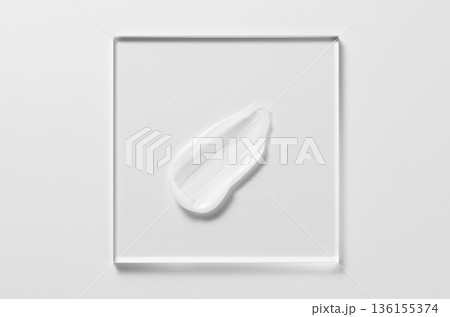 White cosmetic skin care product on glass. White background. White cosmetic skin care product on glass. White background. 136155374